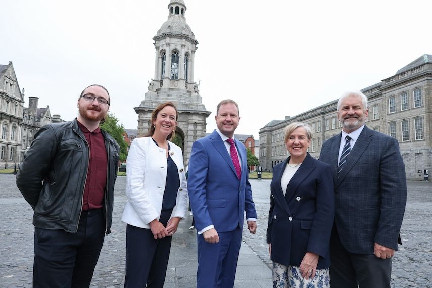 A group of people stands together in Trinity College Dublin
