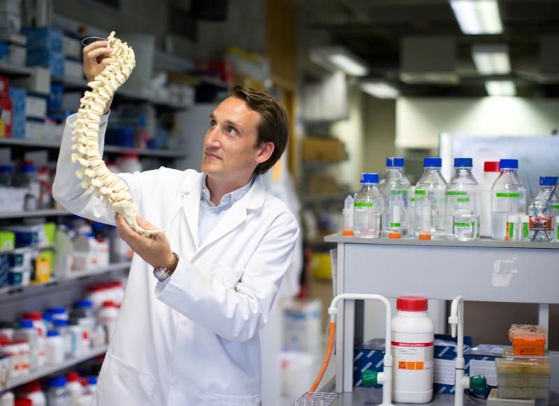 Prof. David Hoey in the lab with a model of a skeleton.