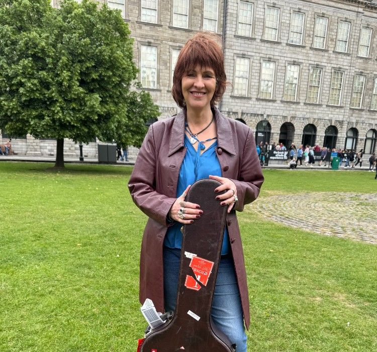 Woman with a guitar case at TRinity