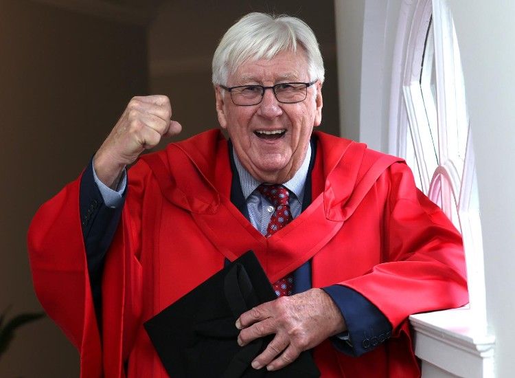 Man celebrates in academic robes