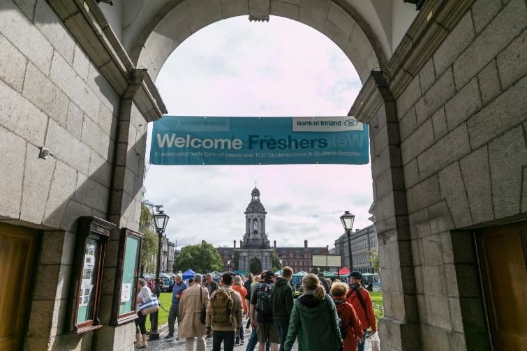 Students entering Trinity under a banner that reads Freshers Week