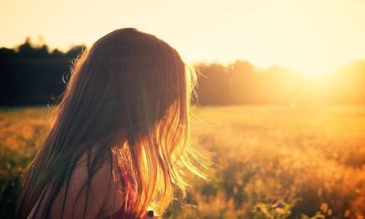 Young girl sitting in the sunshine