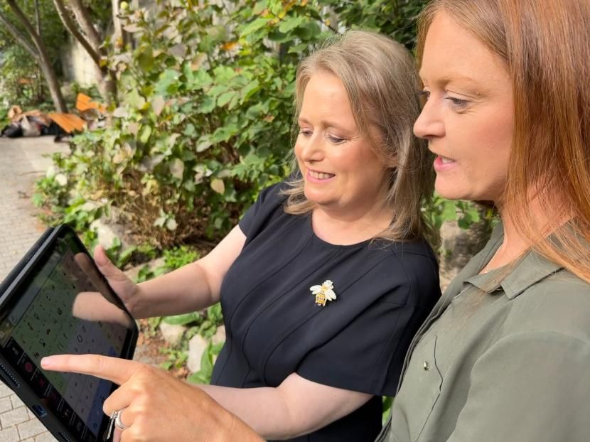 Picture of two women holding a tablet