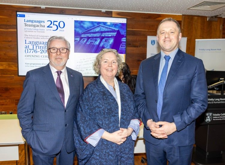 Two men and a woman pose