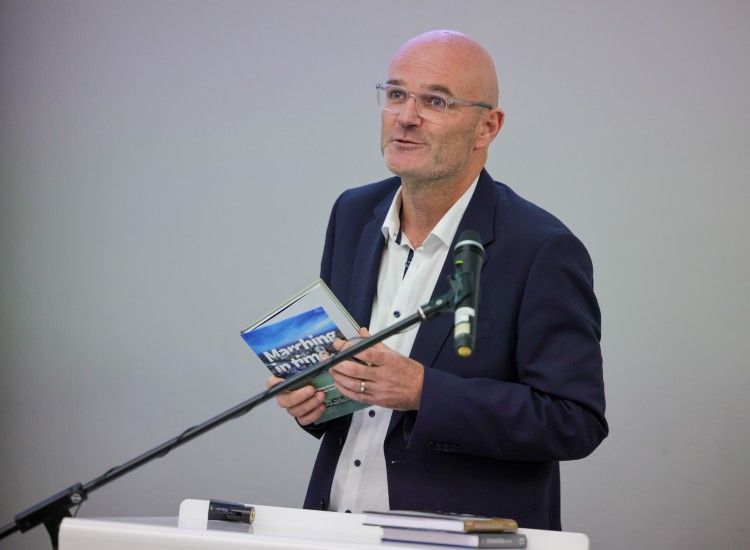 Man with book at podium