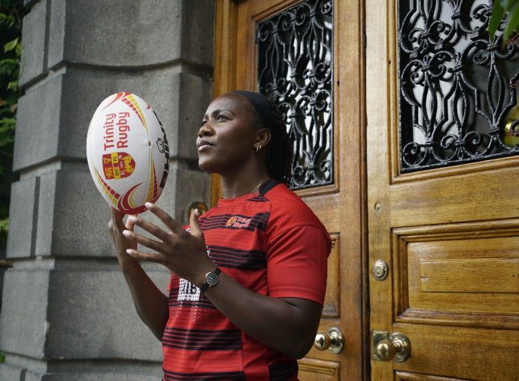 Woman balances rugby ball