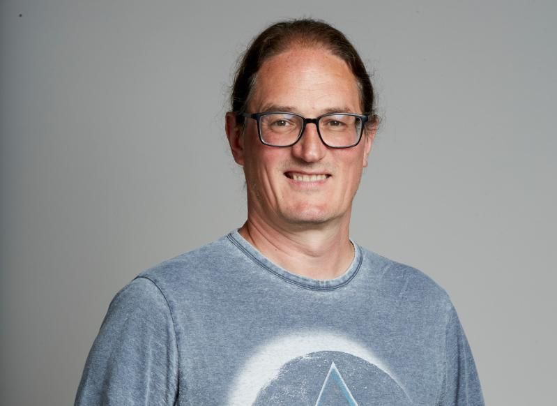 Prof. Jonathan Coleman wearing a Pink Floyd T-shirt.