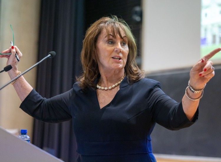 Woman gestures on a podium