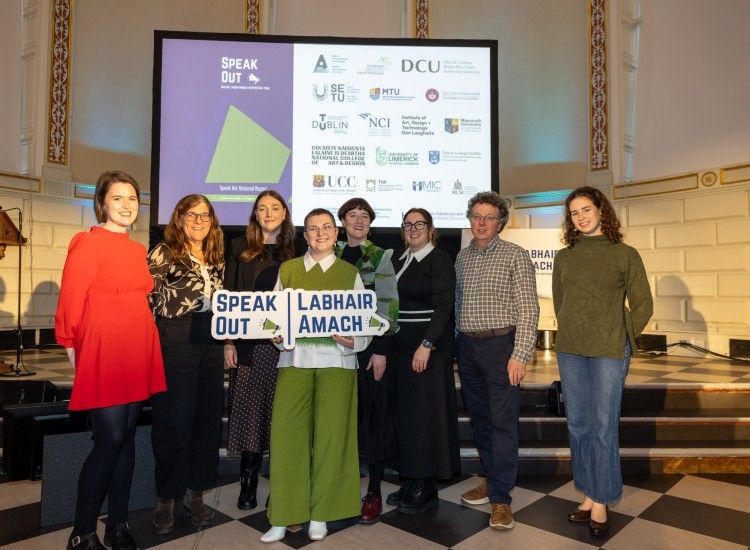 group of people pose in front of podium