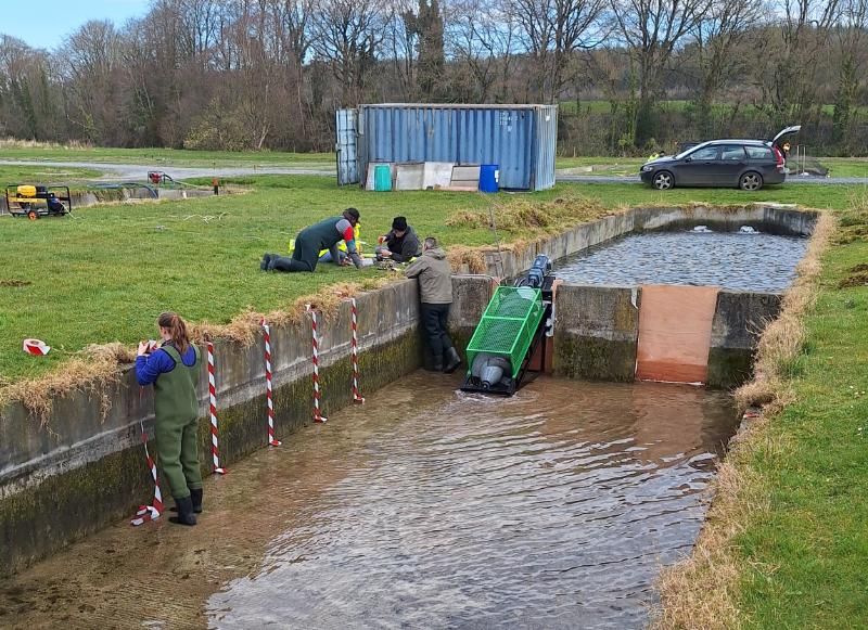 The Trinity and UCD team test the prototype unit in the field, at a river location where water is impacted by a barrier.