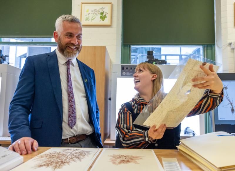 Minister Christopher O’Sullivan looks at a plant specimen in the Herbarium.