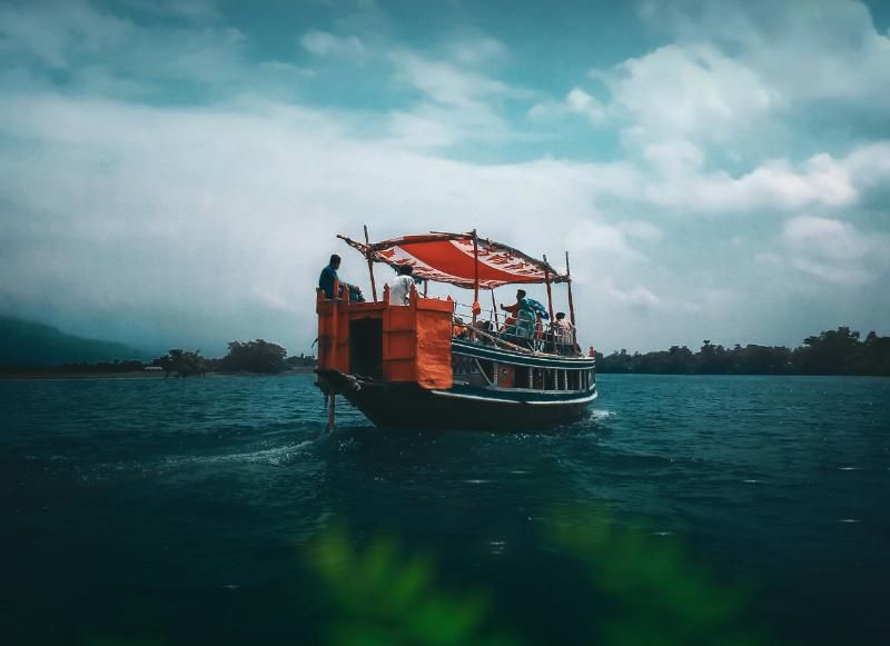 A fishing boat with red sailes in waters of Sylhet, Bangladesh. Image by Ebadur Rehman Kaium, Unsplash.