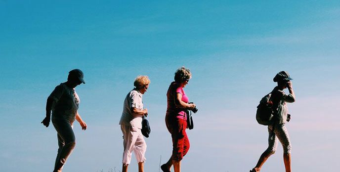 four senior female hikers