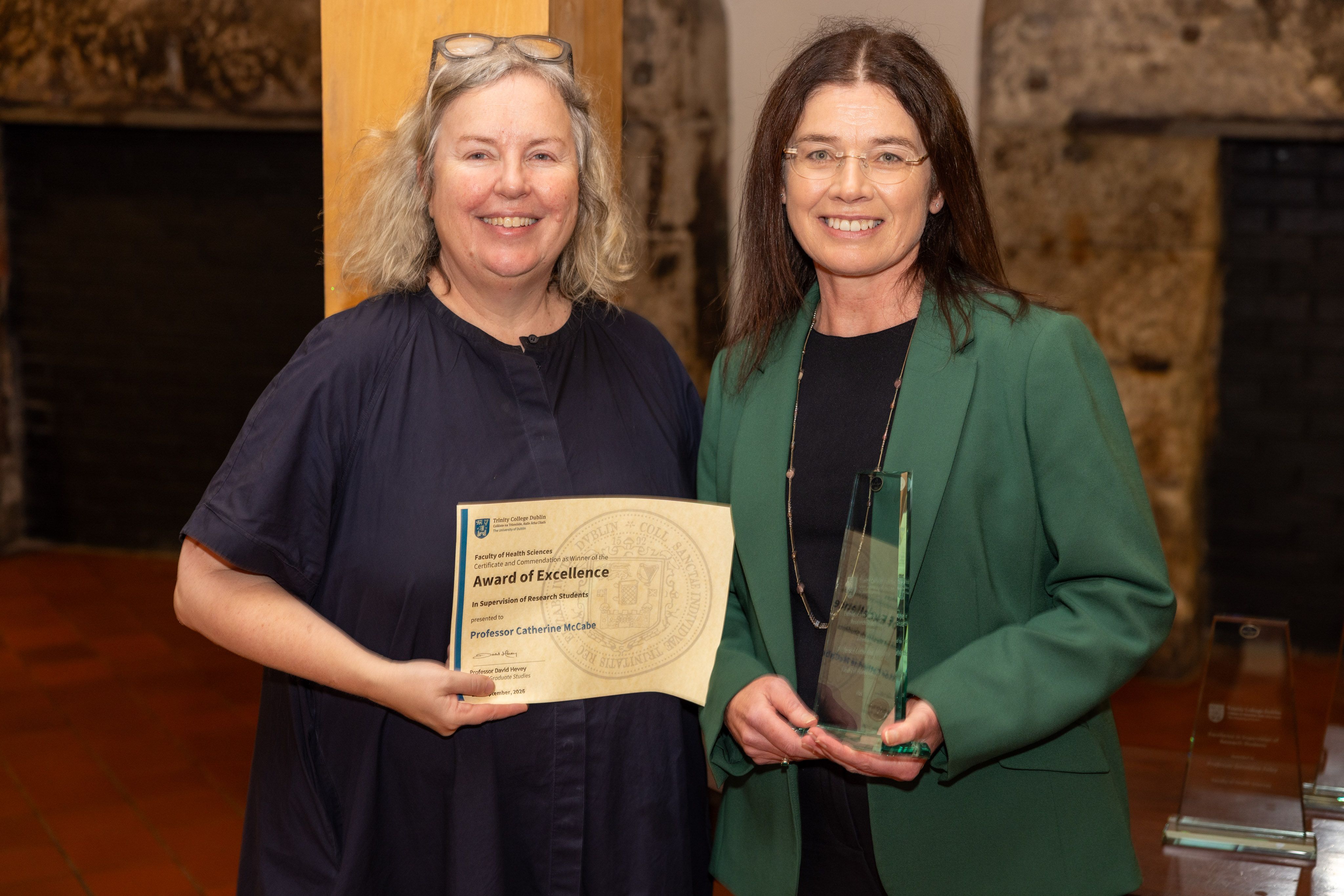 Two people with awards