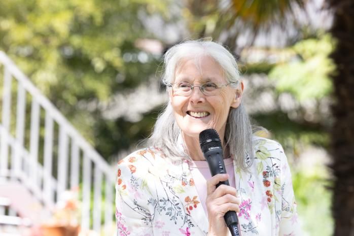 Professor Cecily Begley with microphone