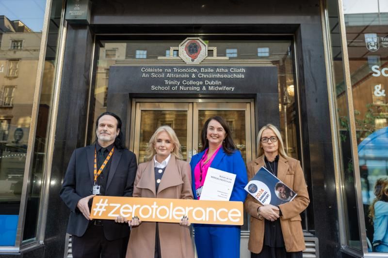 Group holding a sign which says zero tolerance