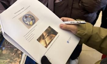 Person holding a quiz sheet at undergraduate open day