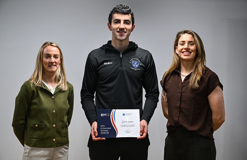 Ciarán Lennon of Trinity College Dublin, centre, is presented with his certificate by Trinity College Dublin Student Sport Pathway Manager Lisa Cafferky, left, and GPA national executive committee co-chair and Dublin camogie player Aisling Maher during the GPA Enhanced Scholarship Awards 2026