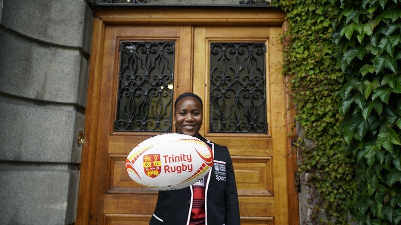 Linda Djougang in DUFC kit and Trinity Sport ambassador jacket at the Botany department door