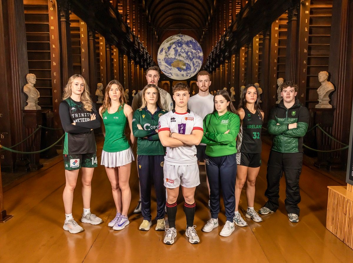 Trinity Sport Scholarship 25-26 photoshoot in Old Library featuring Back row: William MacDonald Hughes (Fencing) and Ryan O'Dwyer (GAA); front row: Ava Learn (Basketball), Sarah Hawkshaw (Tennis), Georgina Dempsey (Cricket), Oscar Cawley (Rugby), Gemma Whelan (Deaf swimming), Hazel Finn (Basketball), and Ethan Bouchard (Alpine skii).