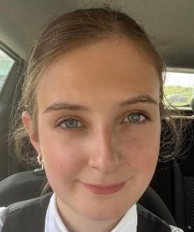 Student with brown hair smiling