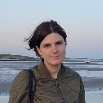 Student facing camera with sea in background.