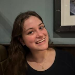 Student with brown hair smiling