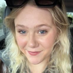 Student with blonde hair smiling