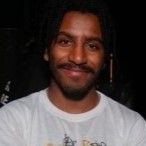 Headshot of student smiling, they are wearing a white tshirt
