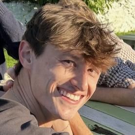 photo of a student smiling at the camera, he has light brown hair