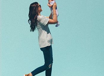 Mother holding up child