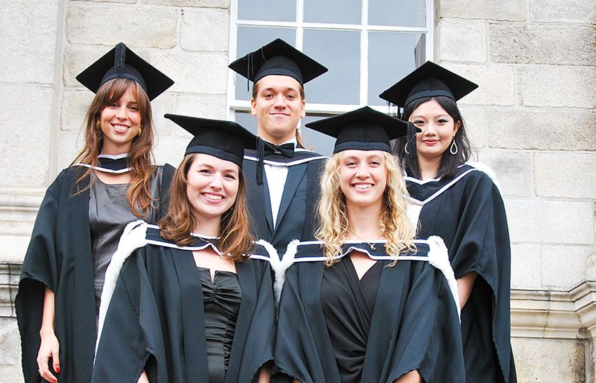 Group of 5 graduates in cap and gown