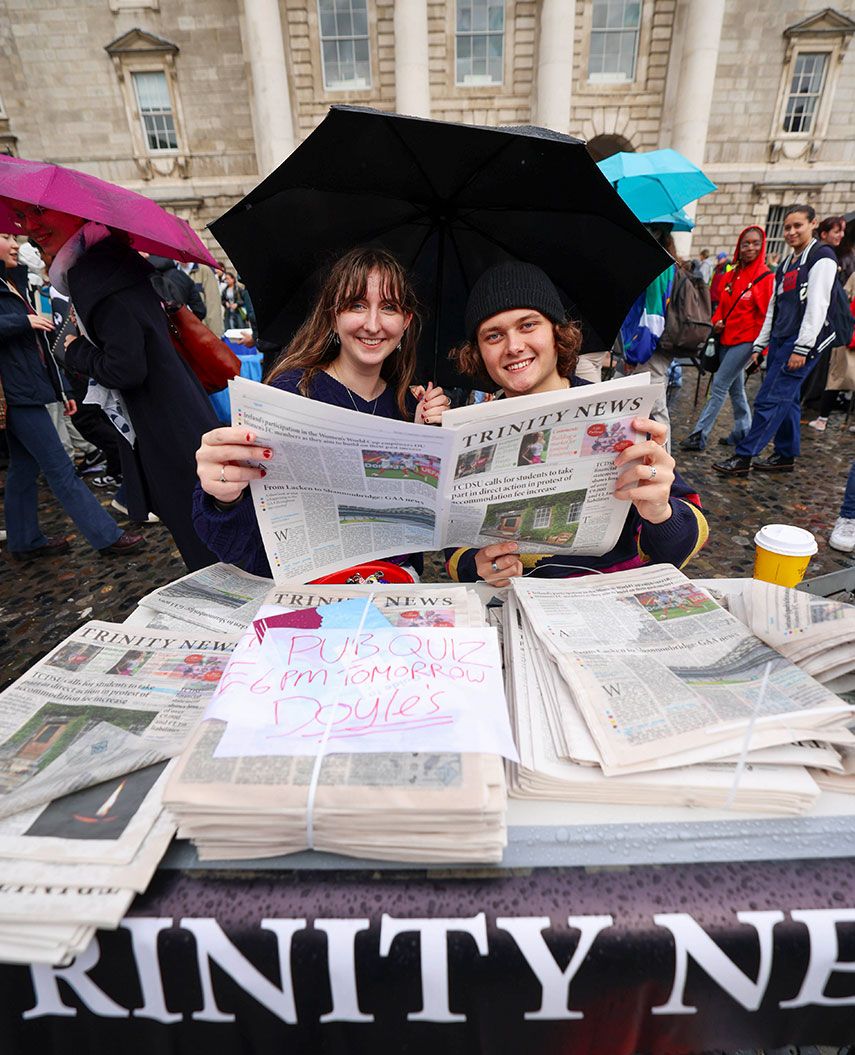 Students holding a copy of Trinity