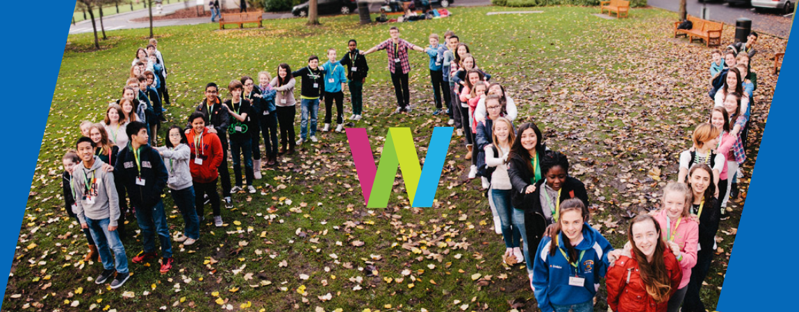 Students standing in the shape of a W